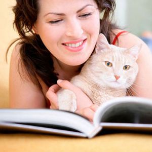 woman reading with cat