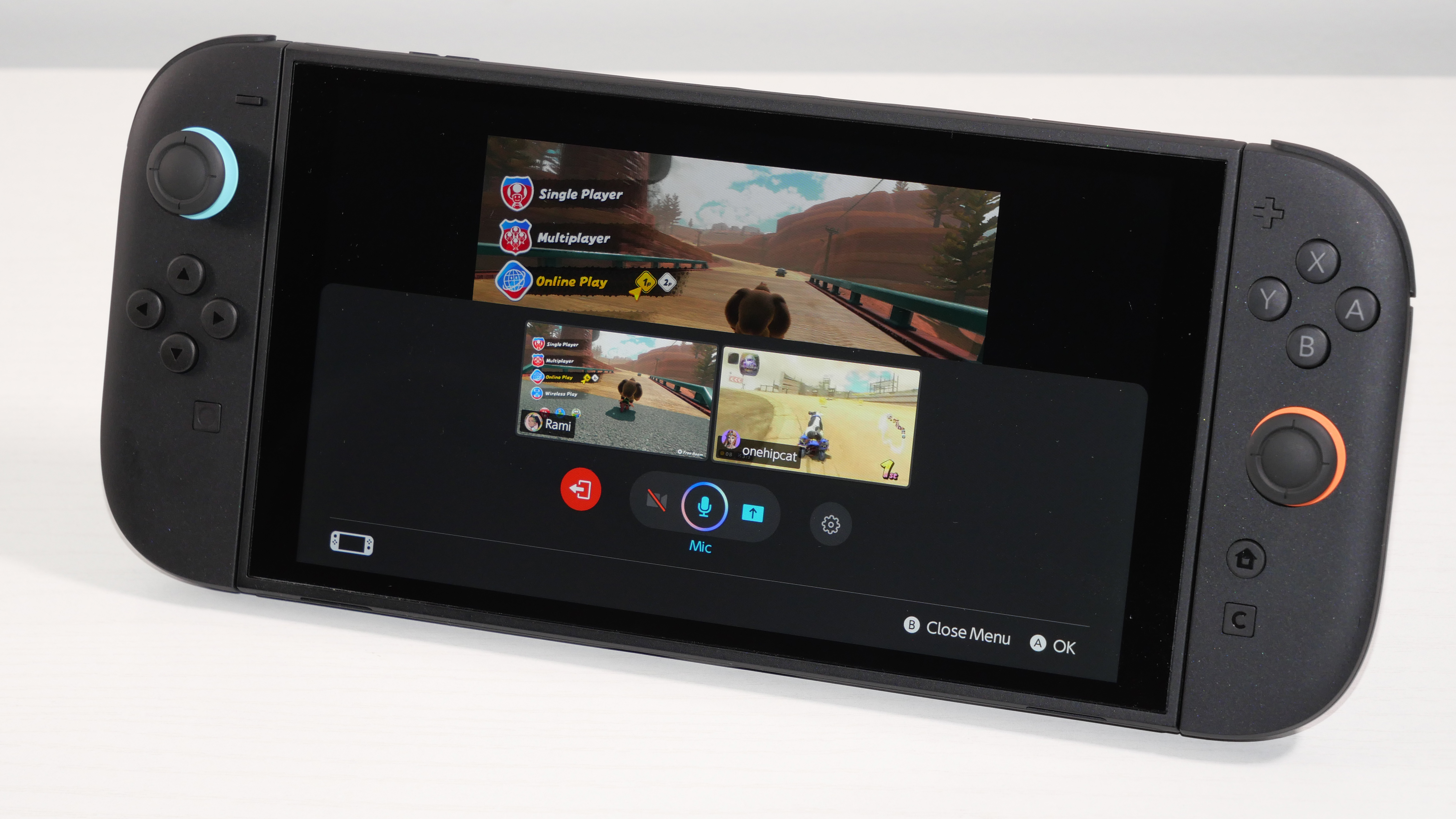 Nintendo Switch 2 laying on a white desk, highlighting GameChat Settings.