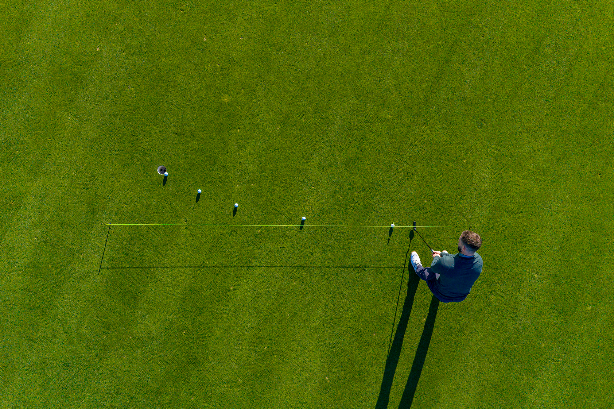 Putting Specialist Coach James Jankowksi from an aerial view of using putting training aids like a putting line