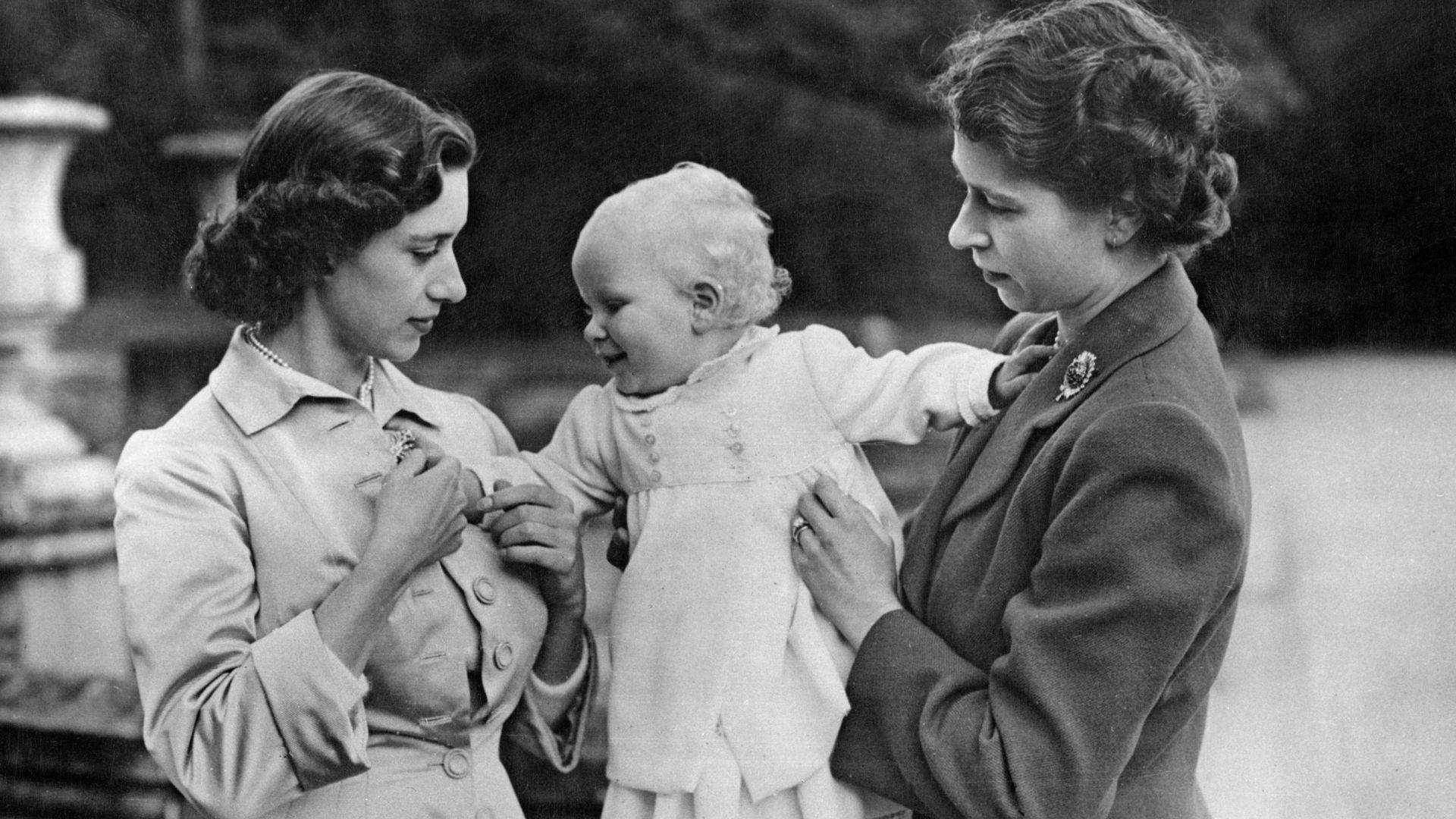 Queen Elizabeth II and Princess Margaret with a baby Princess Anne in the grounds of Balmoral Castle in Scotland, 21st August 1951