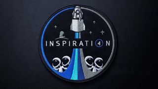 The Inspiration4 Mission Patch Against A Dark Gray Background