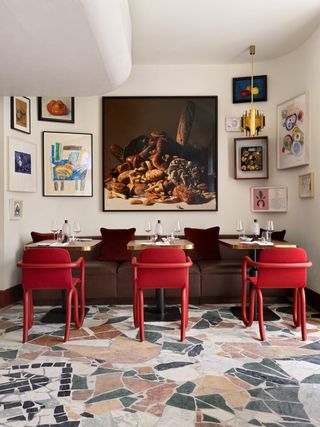 The quirky interiors of Mount St. Restaurant feature playful, unexpected shapes and a mismatch of genres and details, including oddly framed artworks and a marble stone-mosaiced floor.