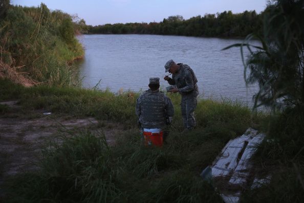 Texas National Guard troops watch the U.S.-Mexico border