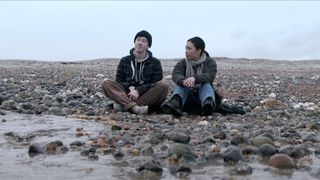 Will and Jin share a tender moment while sat on a British beach in Netflix's 3 Body Problem TV show