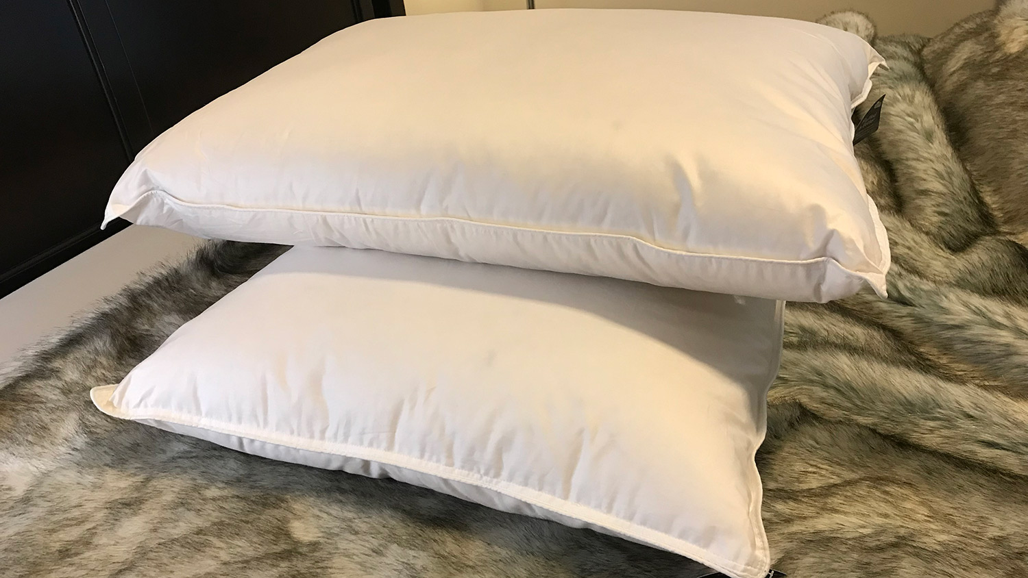 Two Brooklinen Plush Down Pillows stacked on top of one another