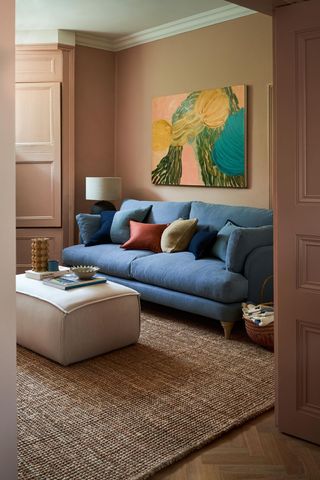 pink living room with blue sofa