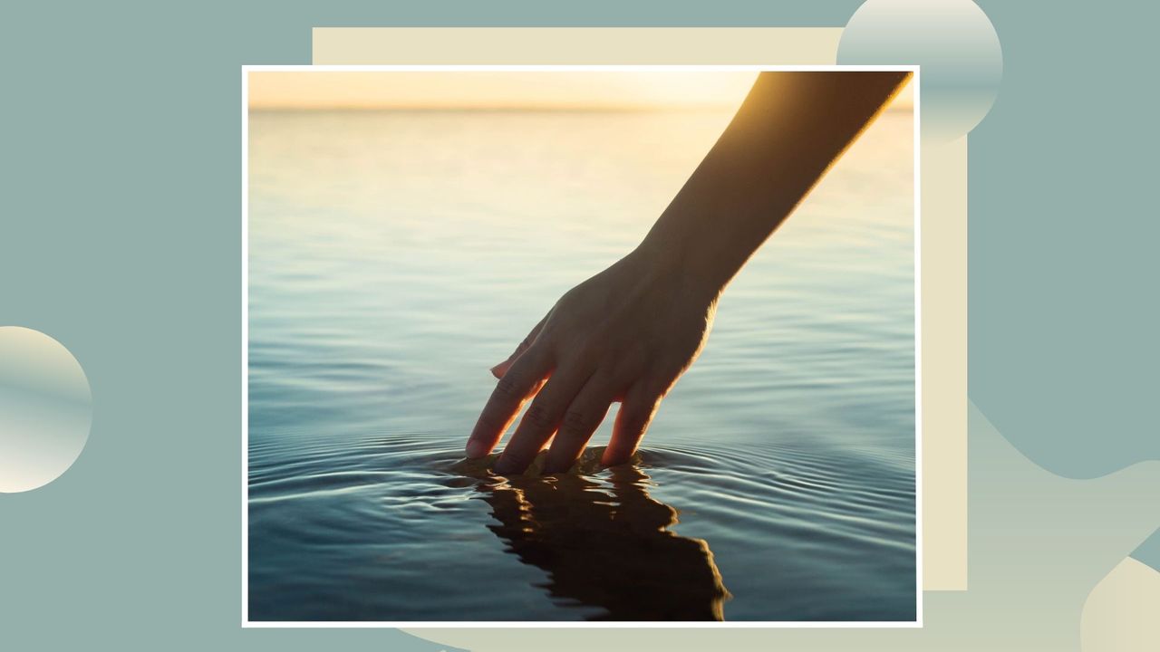 A female hand touching the ocean water in front of a sunset during summer time on a blue and yellow background template