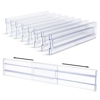 A stack of clear plastic adjustable drawer dividers