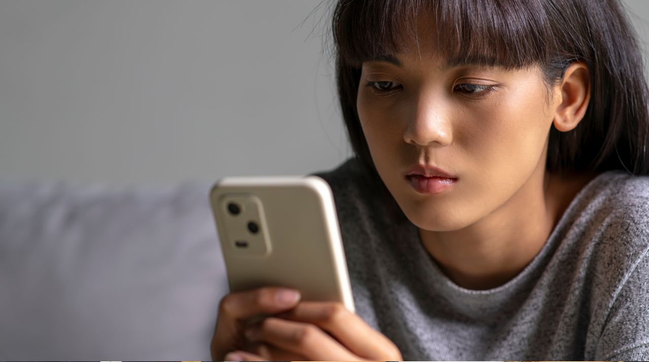 woman staring at her phone