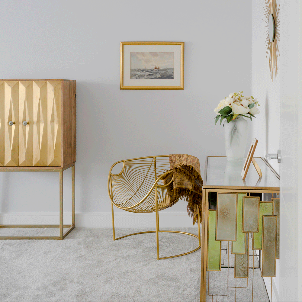 hallway with gold console table and white walls