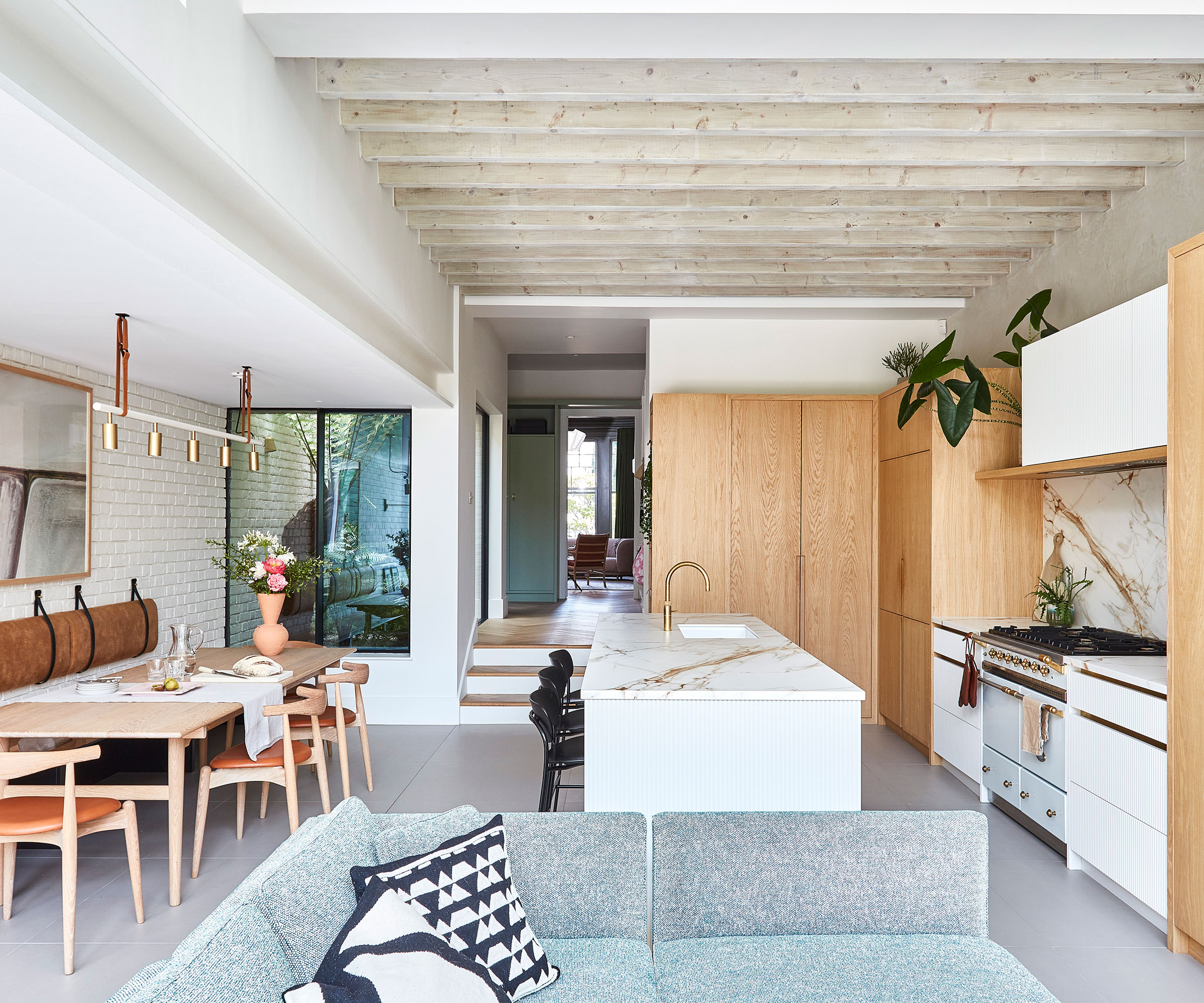 modern open-plan kitchen dining and living room with built-in seating