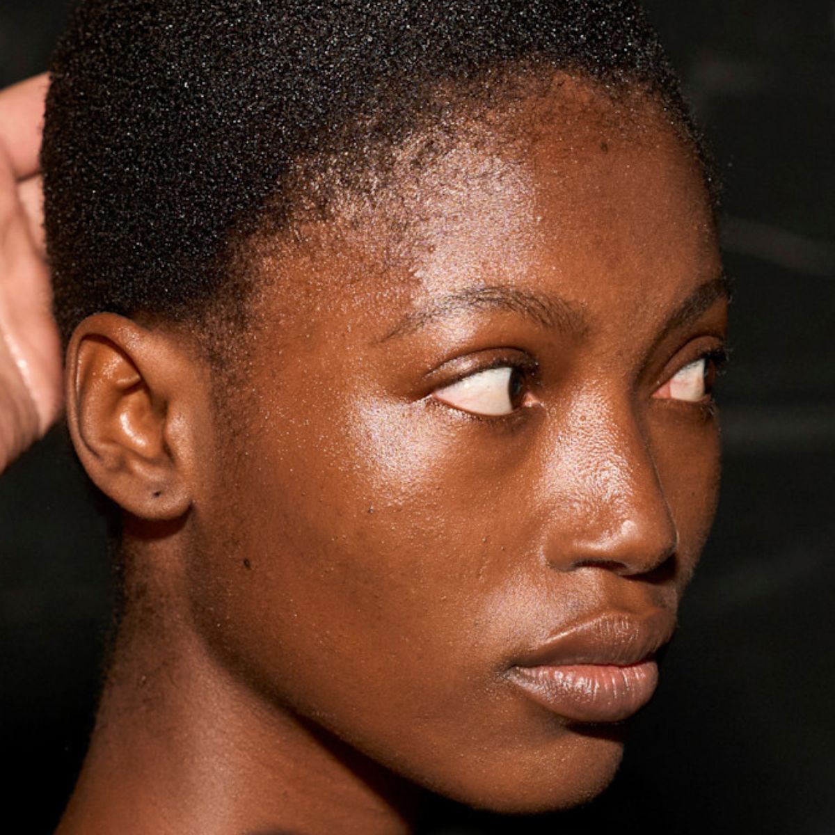model backstage with glowing skin