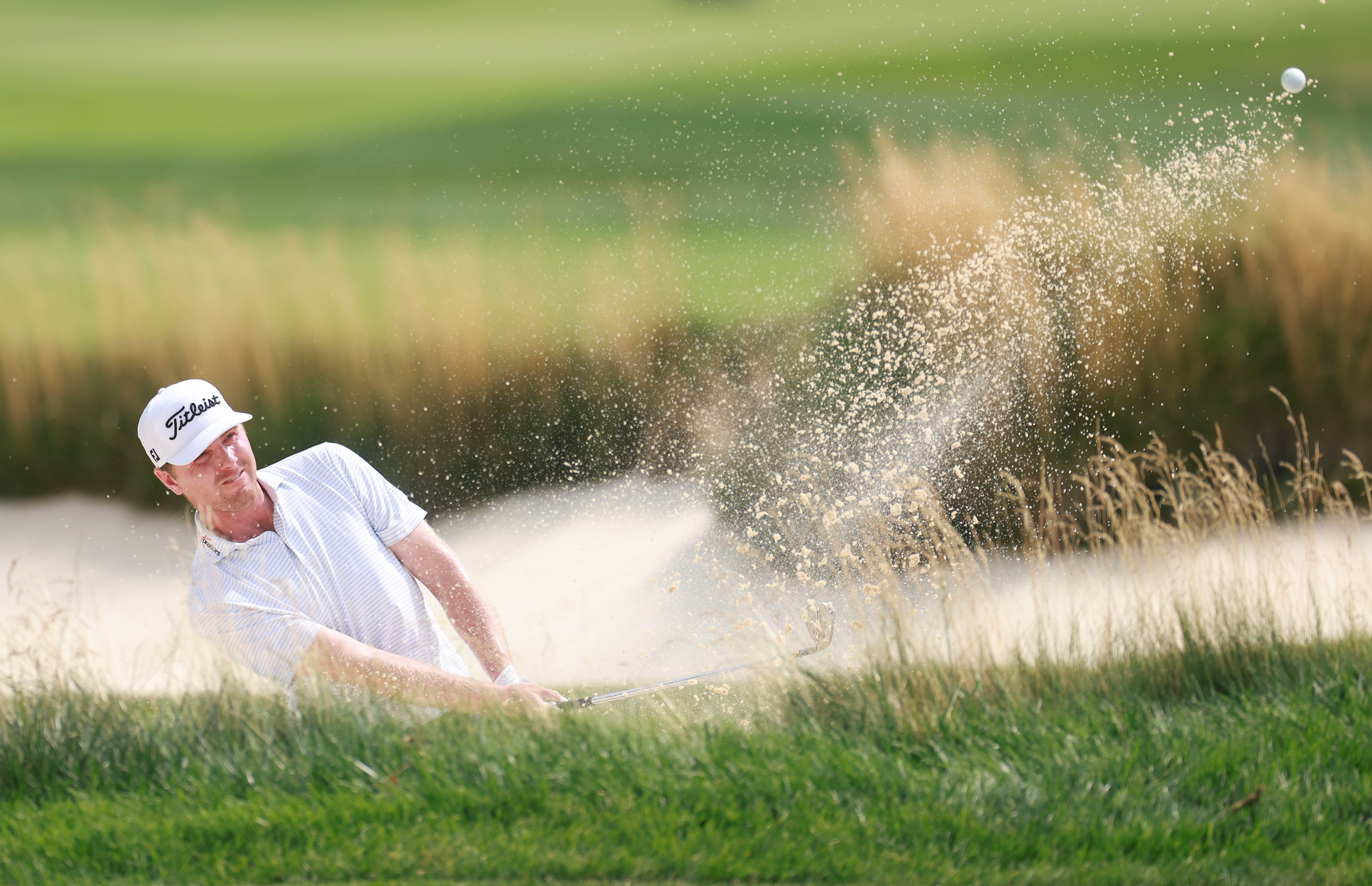 Ryan Gerard of the United States plays a shot from a bunker on the 17th hole during the second round of the Rocket Classic 2026 at Detroit Golf Club (Photo by Gregory Shamus/Getty Images)