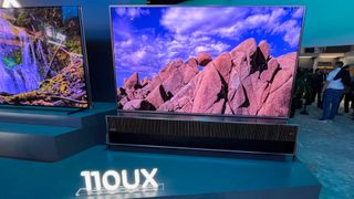 Hisense 110UX TV on display at CES showing image of mountains