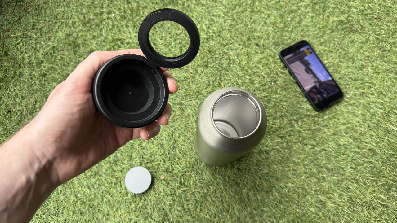 The Journey Reevus water bottle on a faux-grass surface