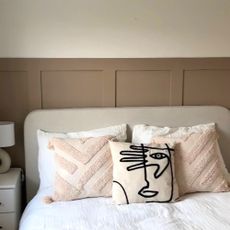 bedroom makeover with pink wall panelling and cushions