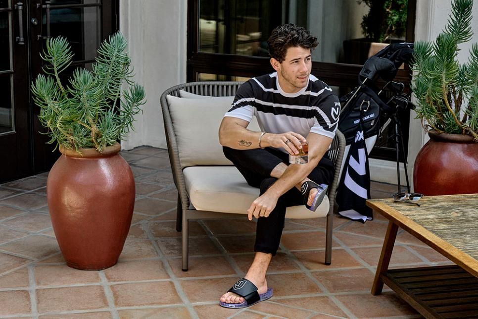 Nick Jonas modelling the knitted golf t shirt as part of his collaboration with PXG