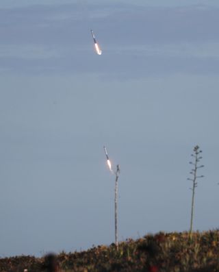 Two of the boosters are seen as they land at Cape Canaveral Air Force Station after the launch of SpaceX Falcon Heavy rocket from launch pad 39A at NASA’s Kennedy Space Center on April 11, 2019 in Titusville, Florida. The rocket is carrying a communications satellite built by Lockheed Martin into orbit.