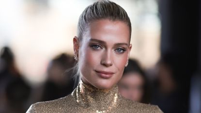  Lady Amelia Spencer seen wearing a golden sequins turtle neck and matching beige pants before the Michael Kors show on February 15, 2023 in New York City.