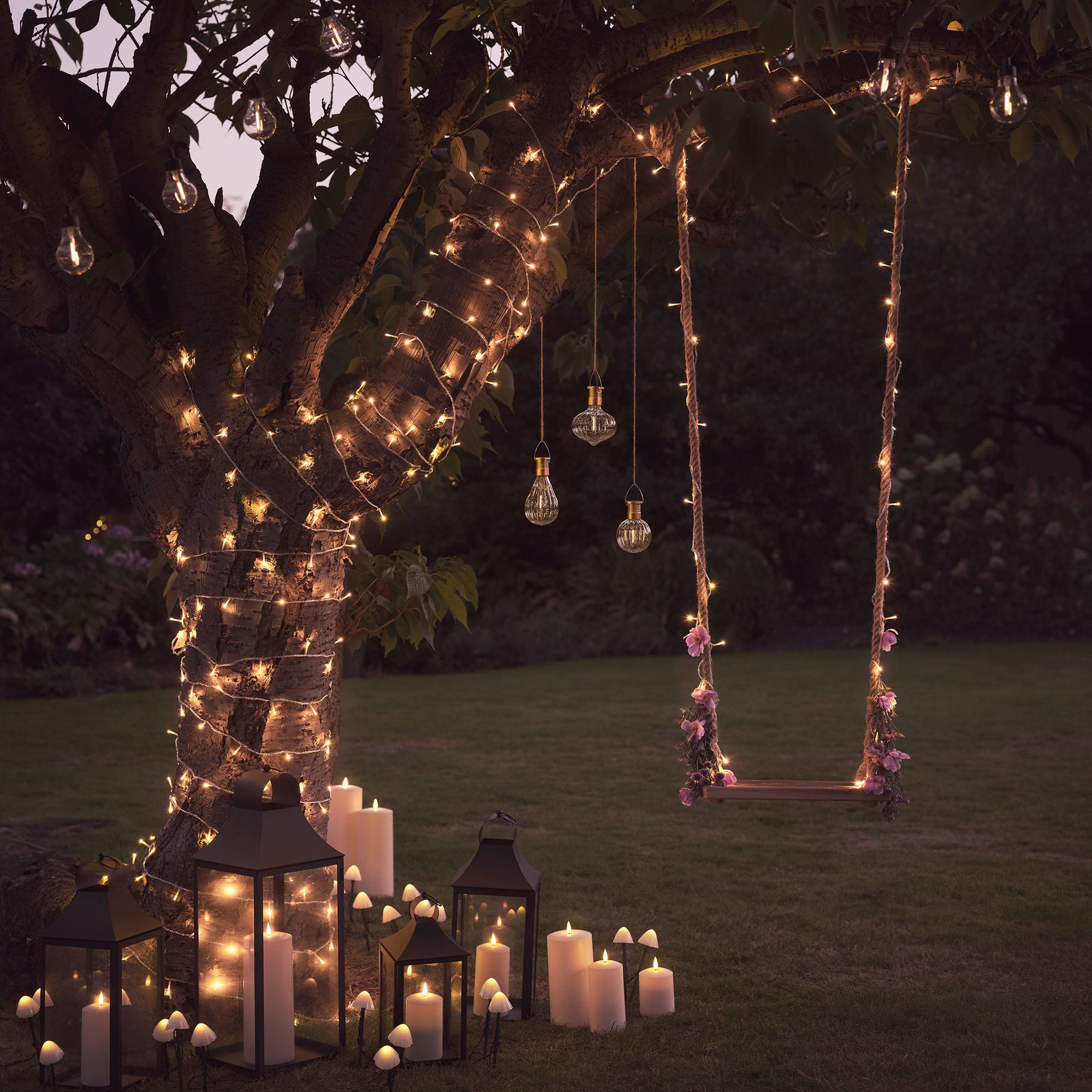 lights4fun Festive Garden Swing at Dusk with Illuminated Tree