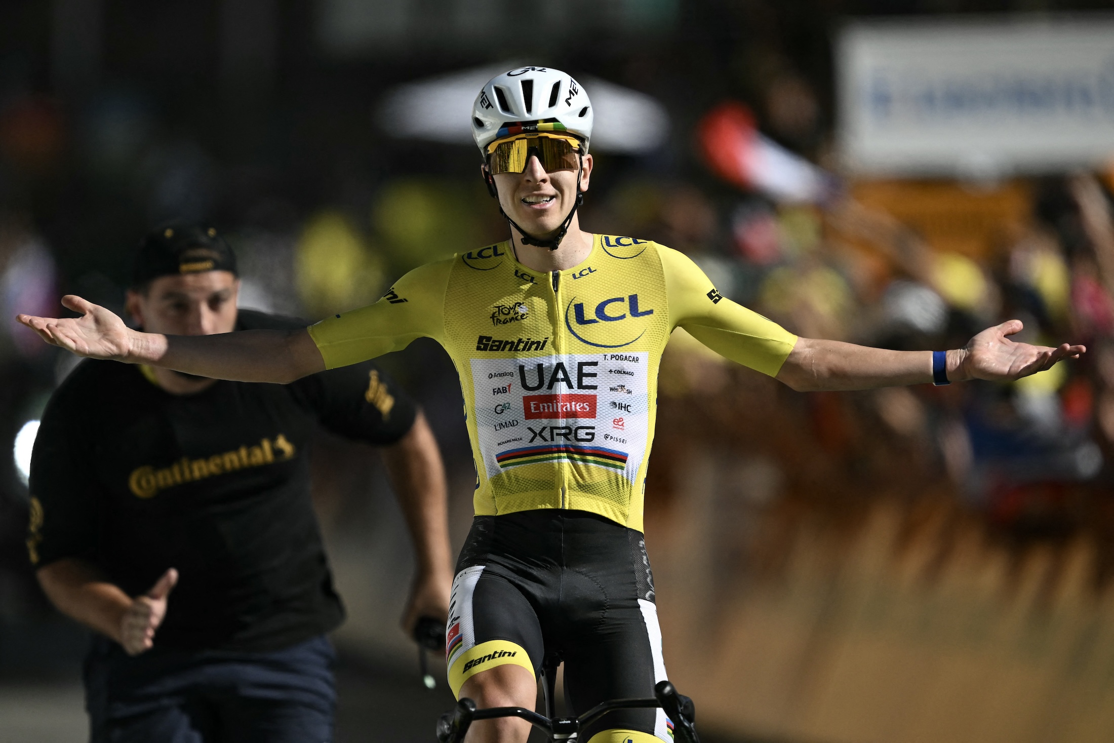 UAE Team Emirates - XRG's Slovenian rider Tadej Pogacar wearing the overall leader's yellow jersey cycles to the finish line to win the 19th stage of the 113th edition of the Tour de France cycling race, 127,9 km between Gap and Alpe d'Huez in the French Alps, on July 24, 2026. (Photo by Jeff PACHOUD / AFP)