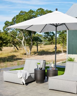 outdoor sun loungers and umbrella by LH Designs