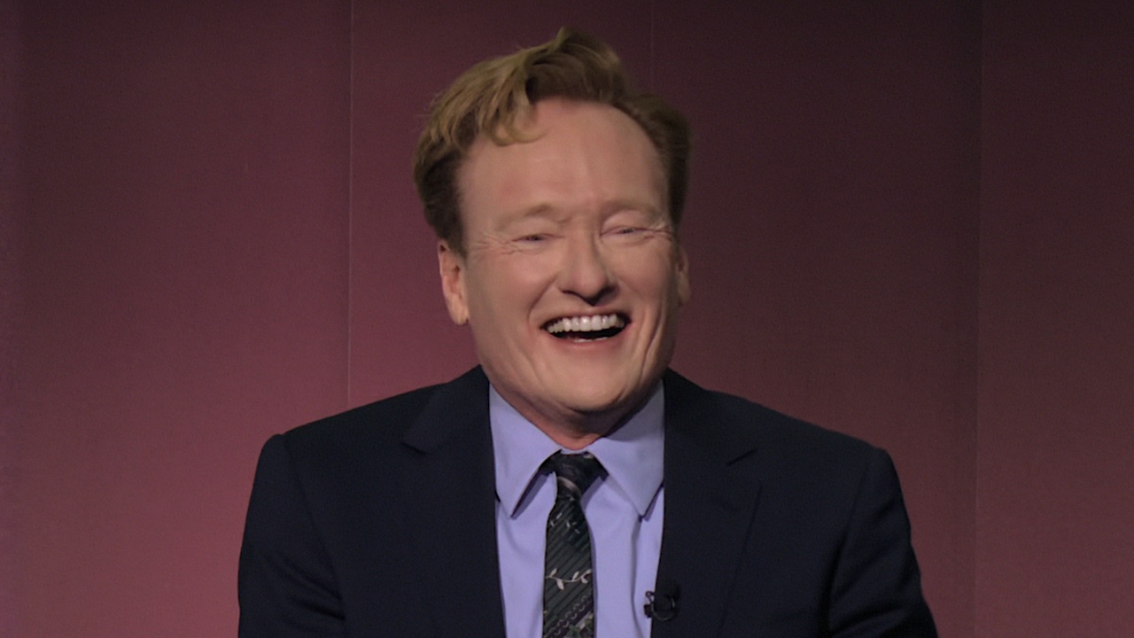 Conan O'Brien laughing strongly during Kumail Nanjiani's segment of Mark Twain Award special.
