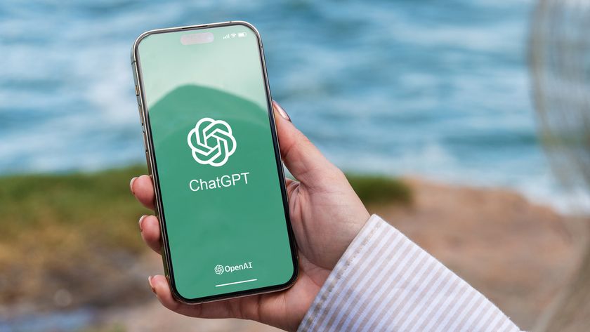 Person holding the phone with ChatGPT logo