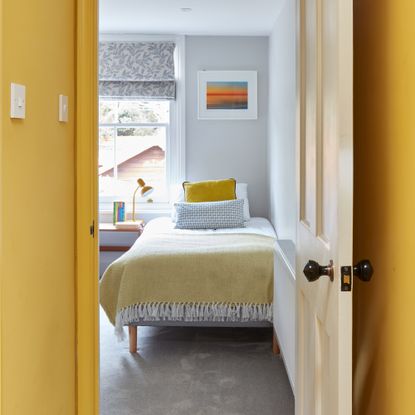 An open doorway revealing a yellow childrens bedroom