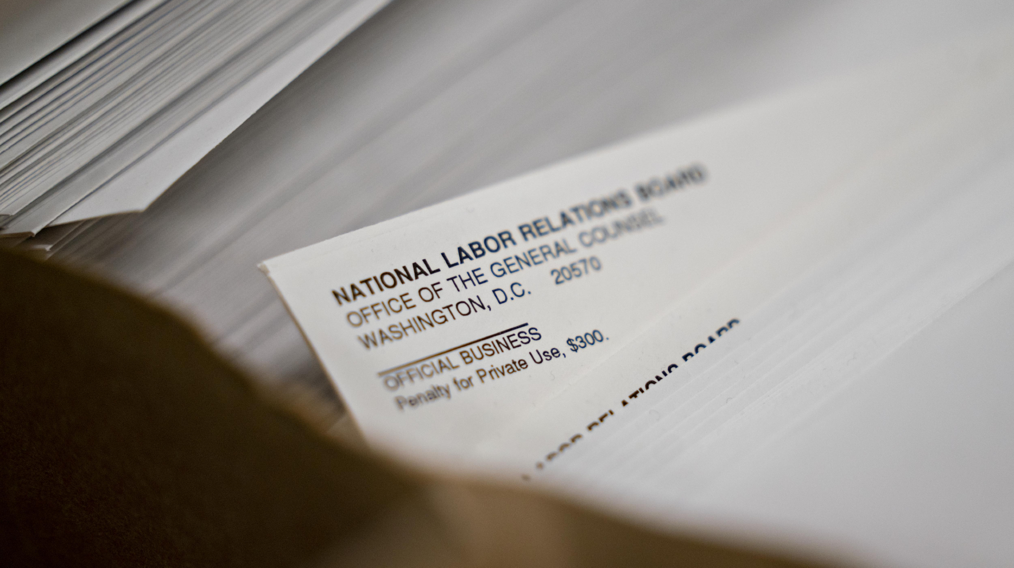 National Labor Relations Board (NLRB) envelopes sit at the headquarters in Washington, D.C., U.S., on Monday, Sept. 30, 2019. Students who receive compensation for teaching or conducting research "in connection with their studies" wouldn't be considered employees, who have the right to unionize and are protected from various unfair labor practices, the NLRB said in a press release Sept. 20. 
