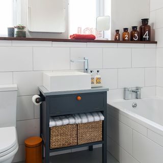 white bathroom with bathtub and walled shelf