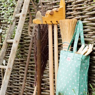 Garden tools hanging on a fence