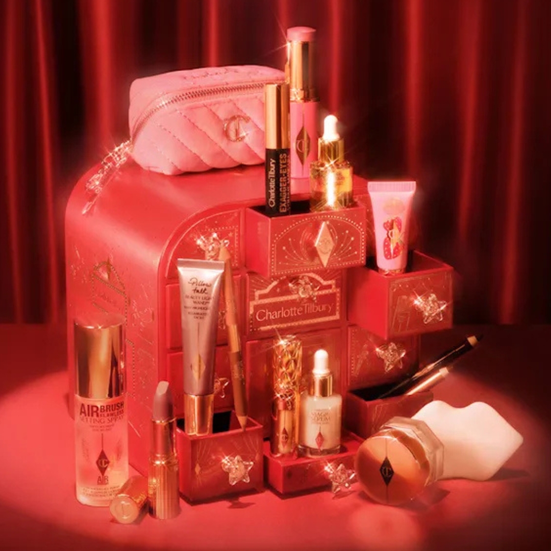 Charlotte Tilbury Charlotte's Hollywood Beauty Wonderland Advent Calendar with its contents in front of it