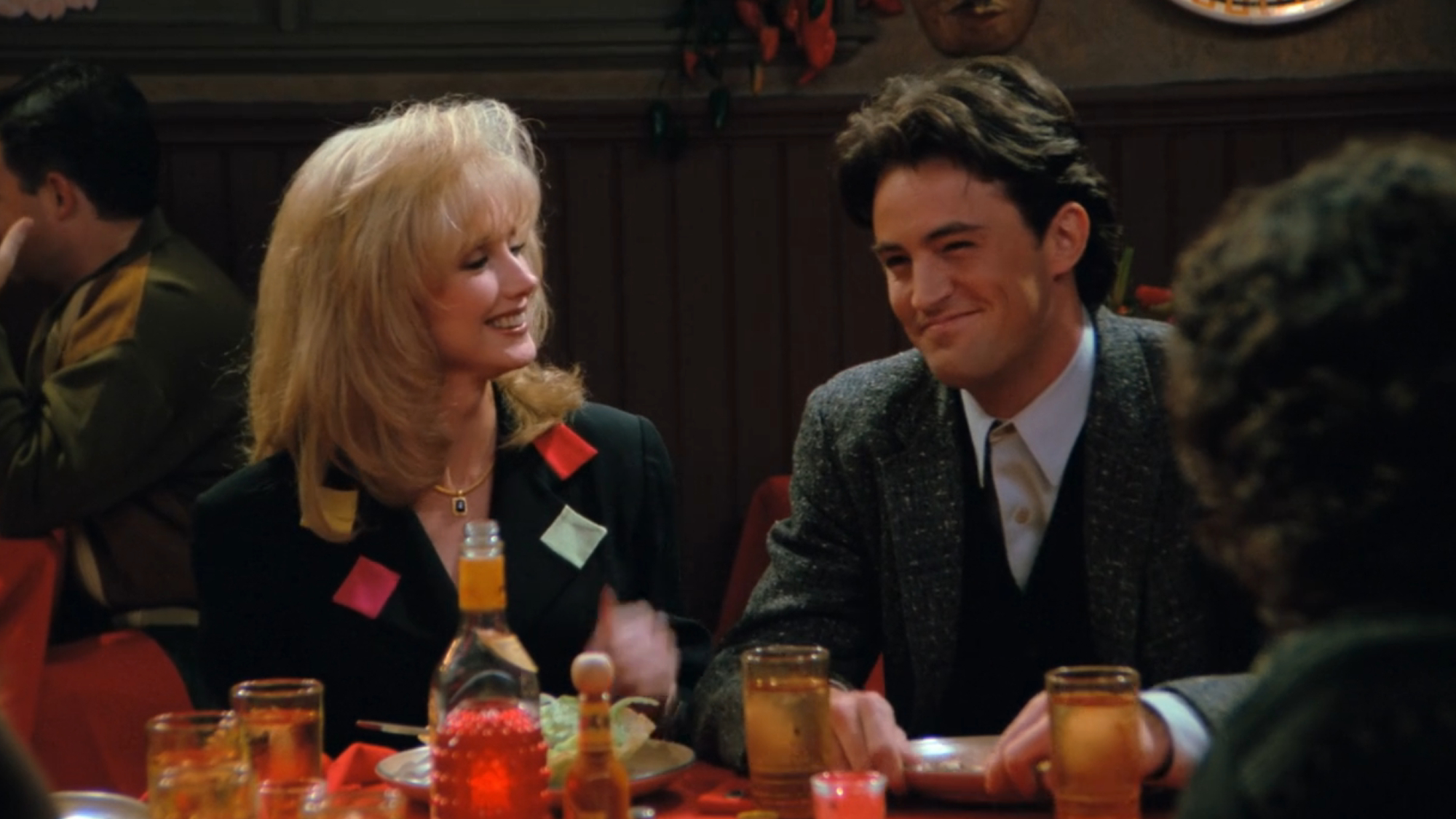 Chandler and his mom Nora Bing sit next to each other at dinner in Friends Season 1, Episode 11.