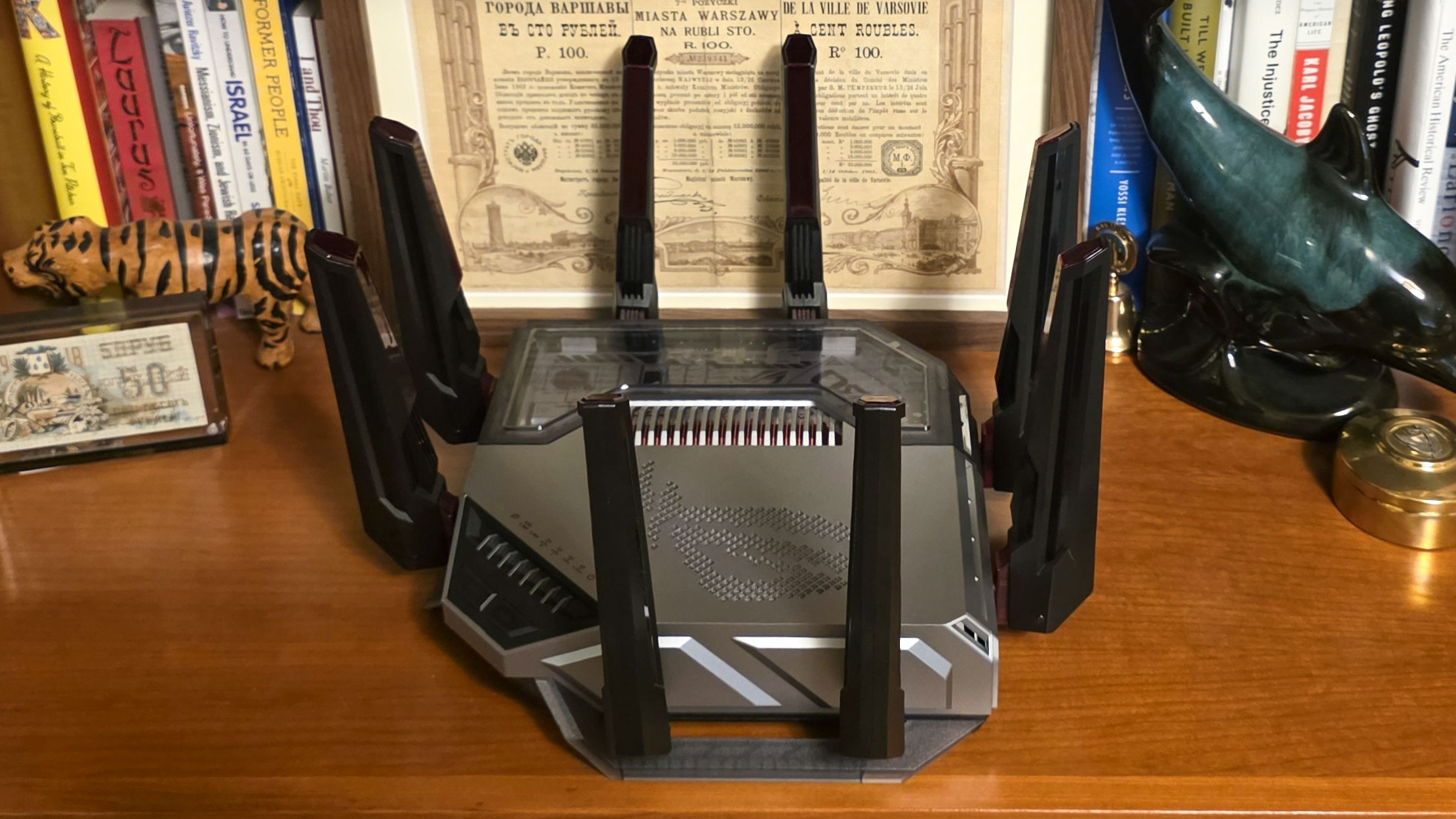The Asus ROG Rapture GT-BN98 Pro seen from the side on a bookshelf