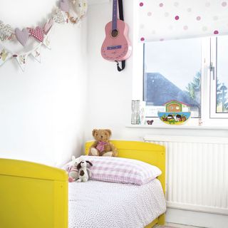 kids room with white walls and yellow bed