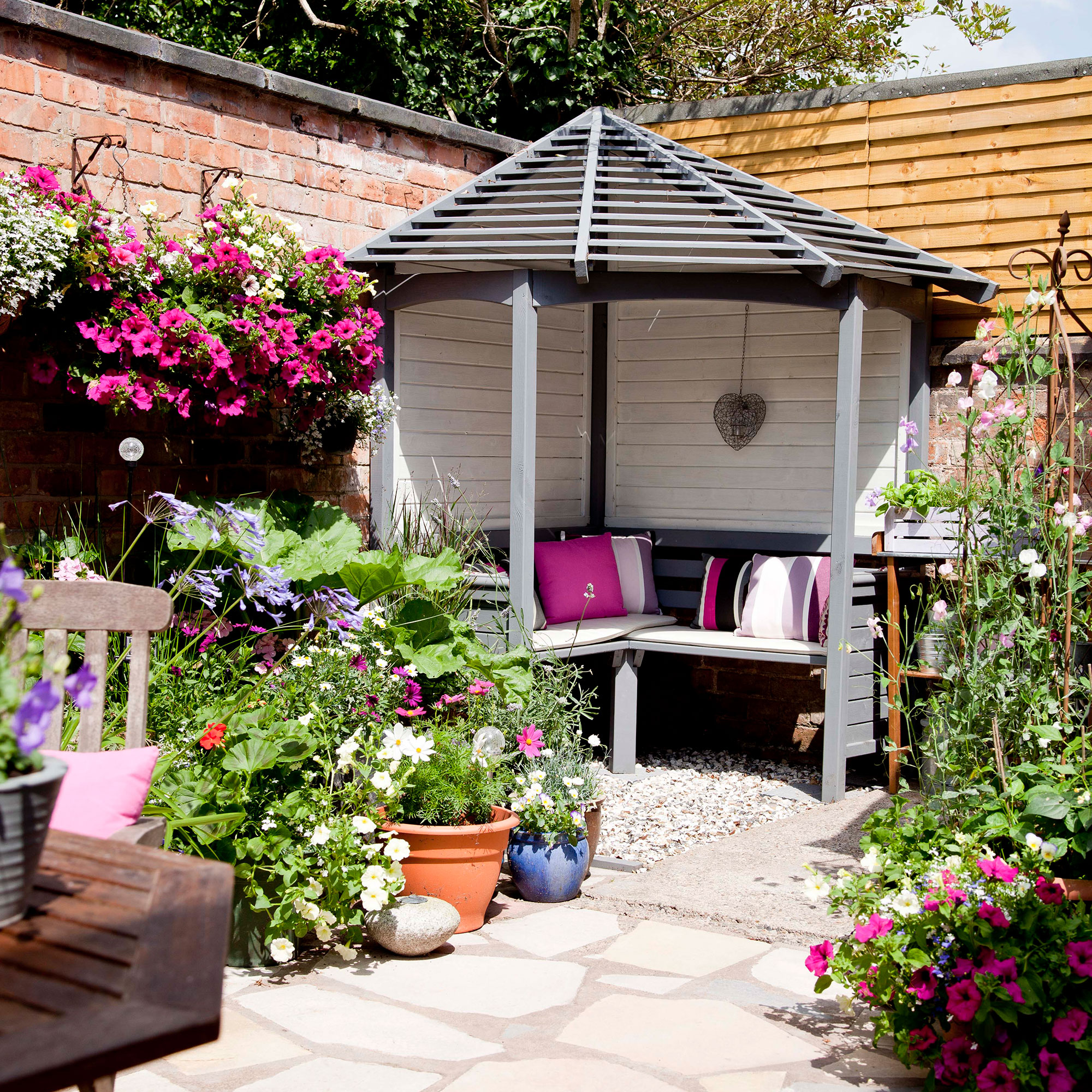 courtyard garden with open summerhouse and potted plants