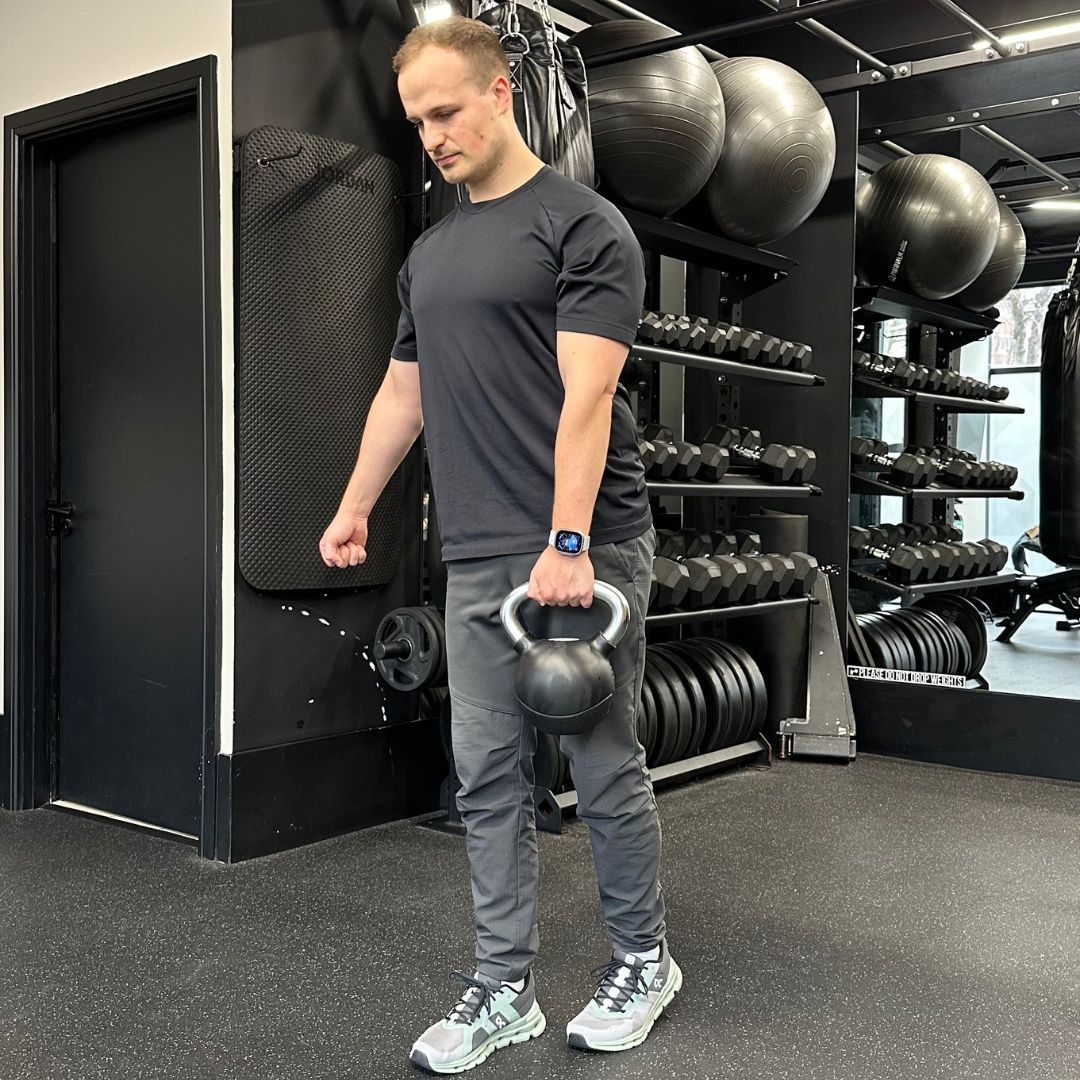 Personal trainer Ollie Thompson demonstrating a B-stance deadlift