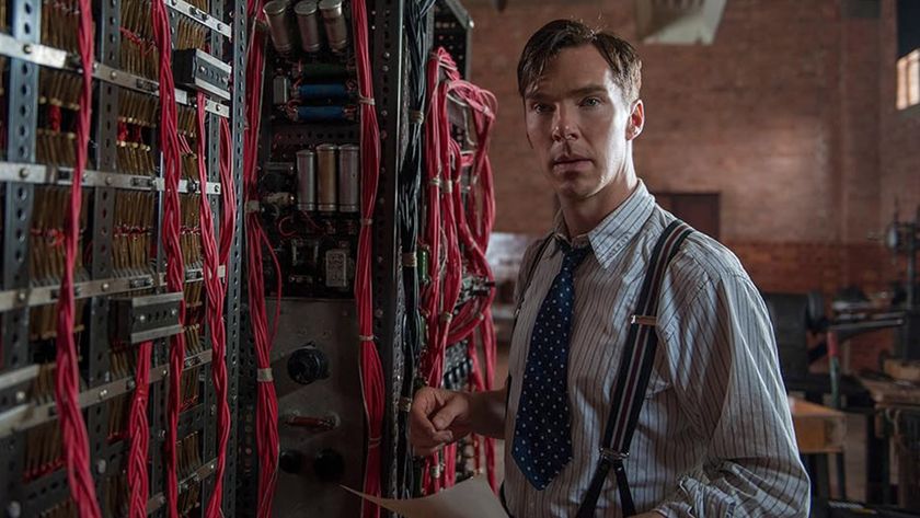 Benedict Cumberbatch stands next to the Bombe machine in The Imitation Game