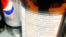 close up on the nutrition label on a bottle of diet pepsi, which includes "aspartame" as ingredient