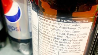 close up on the nutrition label on a bottle of diet pepsi, which includes "aspartame" as ingredient