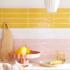 Kitchen with yellow, white and pink metro tiled splashback