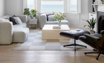neutral living room with beige coffee table and grey sofa 