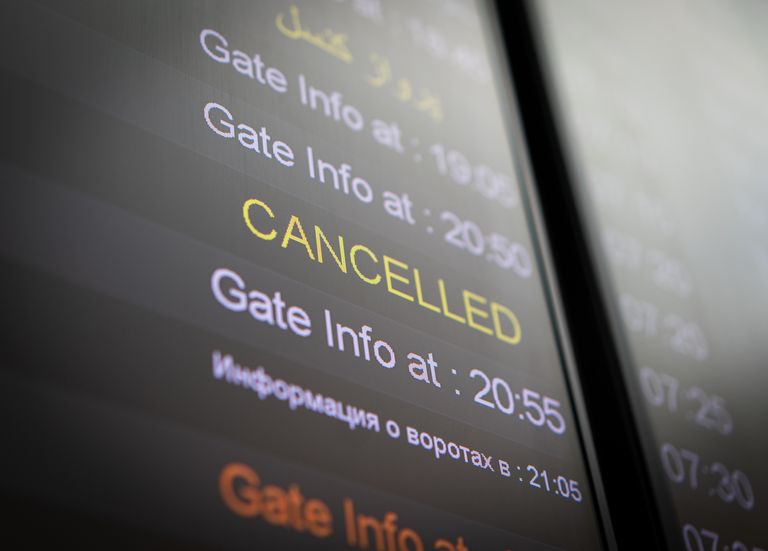 Flight cancelled illuminated on airport arrivals board