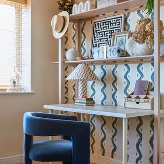 Desk area with desk, shelves above and hand-painted pattern on the walls