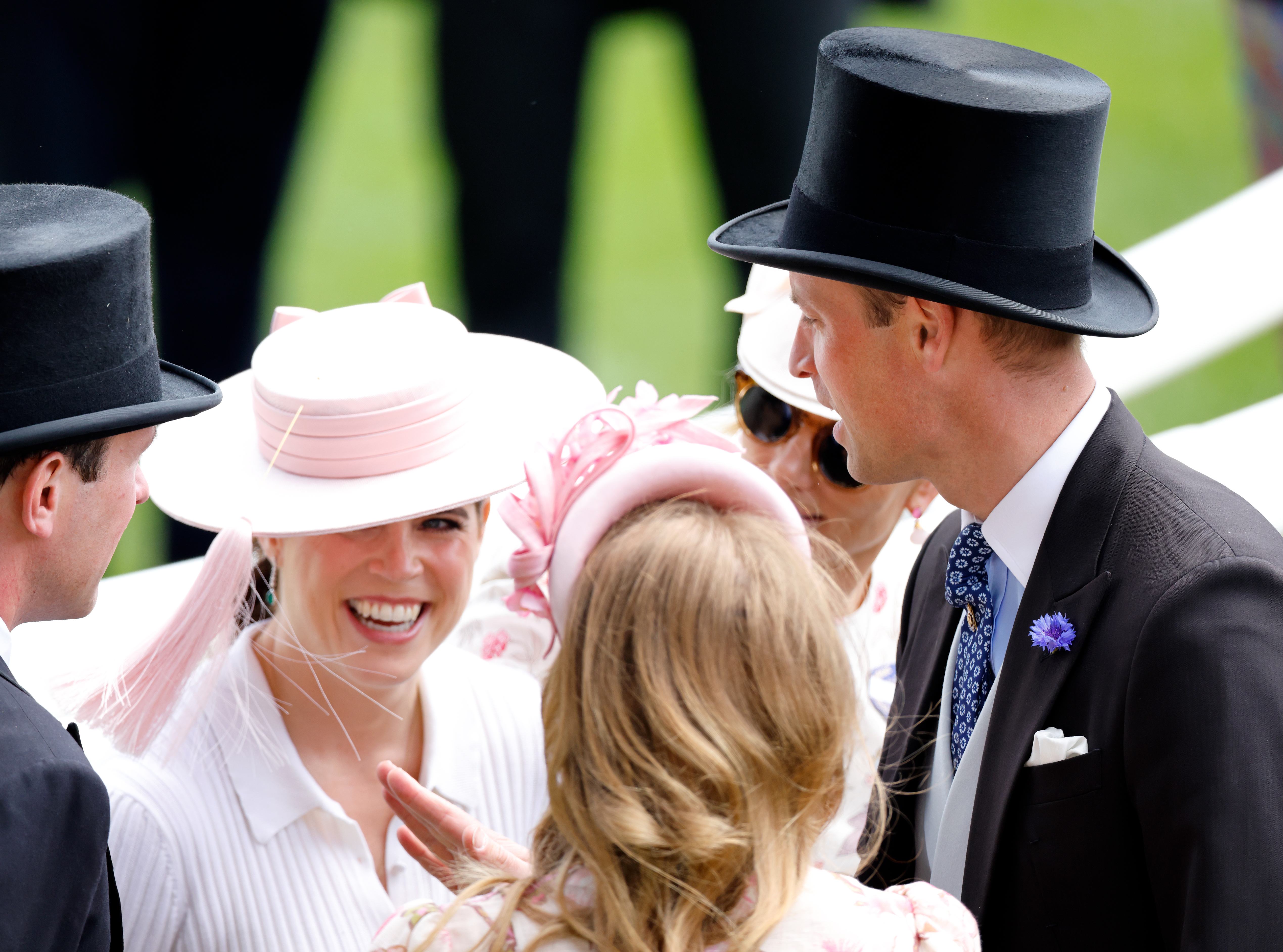 Prince William playing with the tassel on Princess Eugenie's pink hat at Royal Ascot