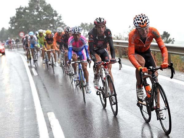 Racers wear long faces on this section of wet road.