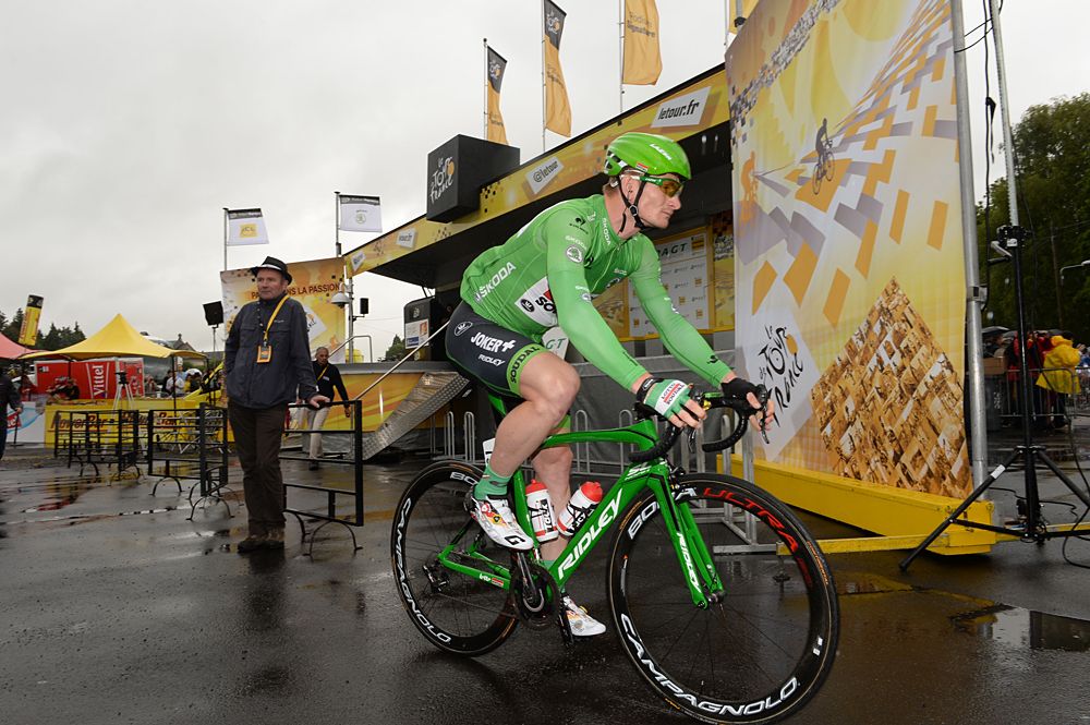 Andre Greipel heads to the start in the green jersey