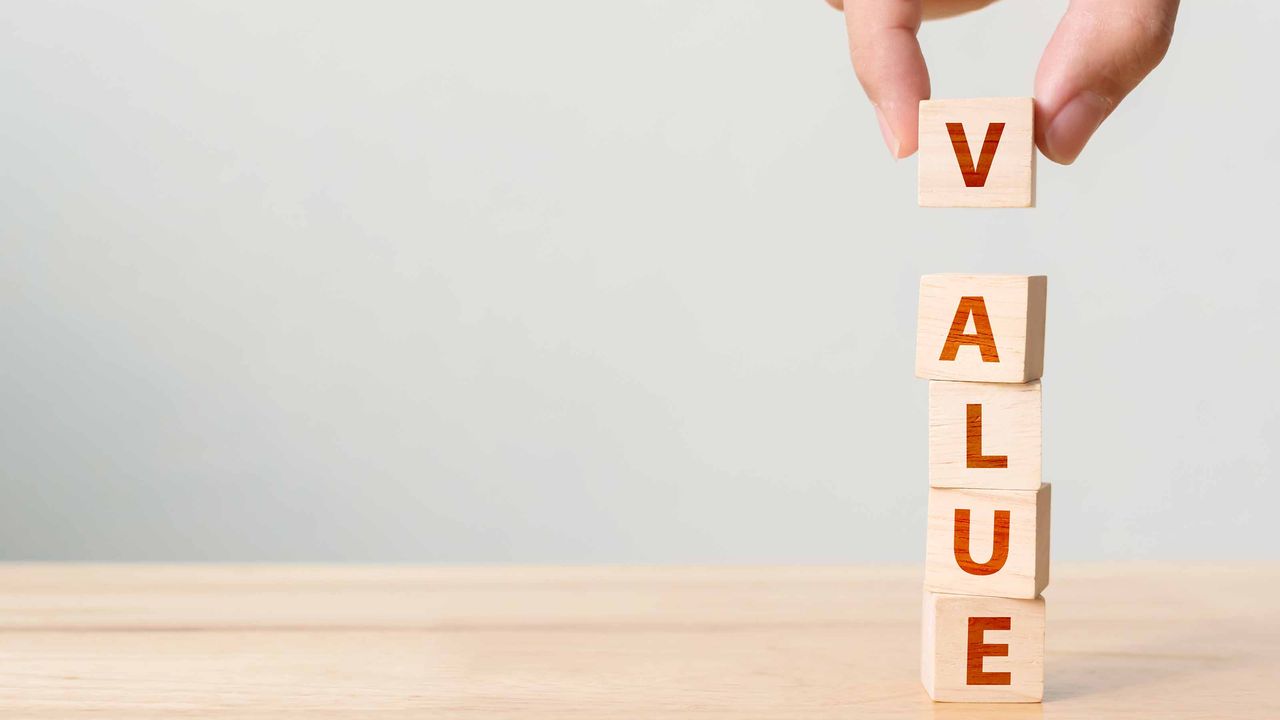 the word &quot;value&quot; written in red ink on stacked wooden blocks