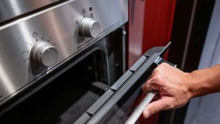 Man opening top door on double oven